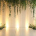 Dazzling White Wedding Backdrop with Luxe Drapes & Hanging Greenery
