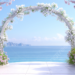 Dreamy Rose-Tinted Wedding Arch Near the Ocean